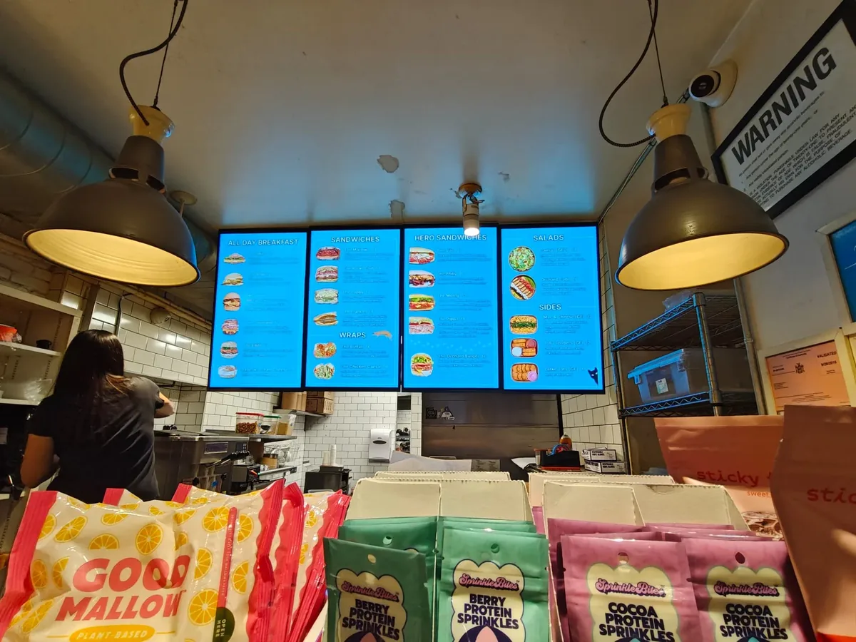 Four-screen menu board kit over a deli counter
